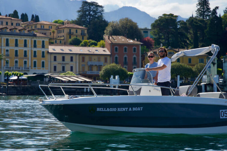 Couple driving a boat in Bellagio Lake Como